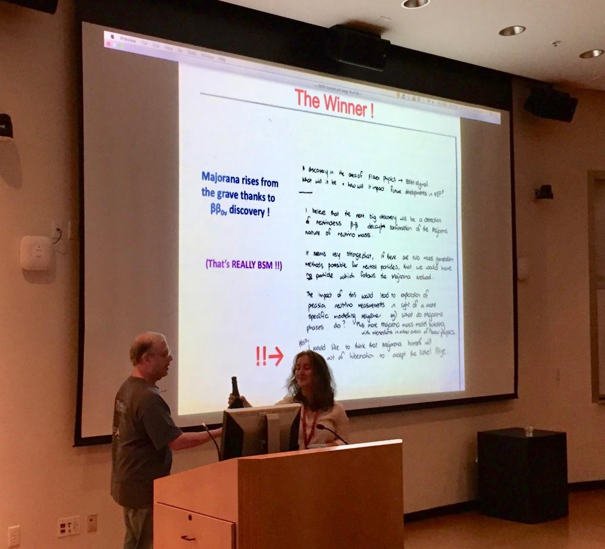 content winner presenting in front of slides