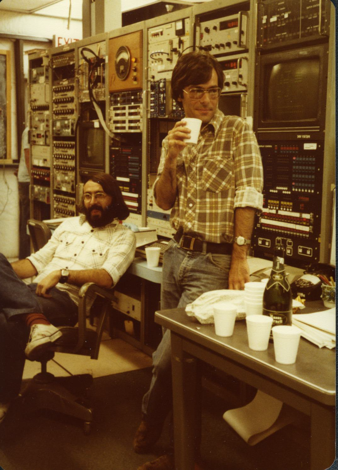 physicists in control room at SLAC celebrating with champaign