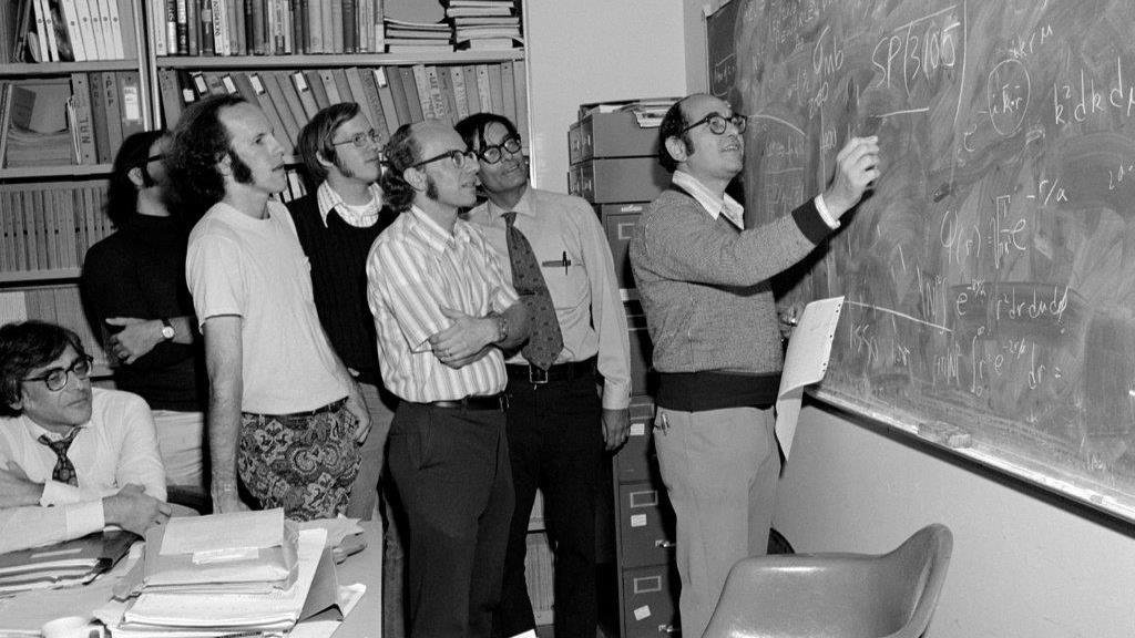 SLAC physicists at a chalkboard