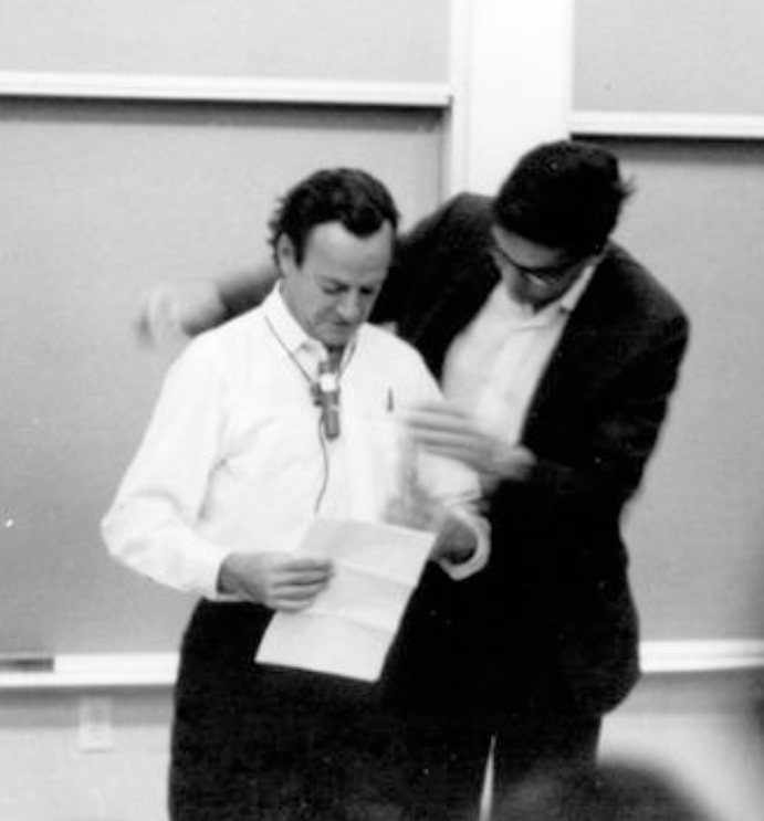 Bjorken assisting Physicist Richard Feynman with microphone