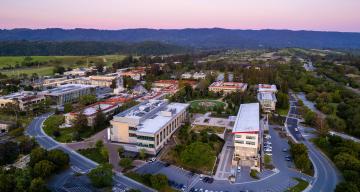 Aerial of SLAC campus looking west at sunset with the main quad 