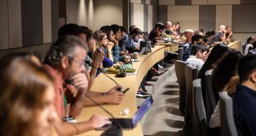 conference attendees viewing a presentation in auditorium