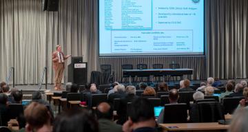 researcher giving a lecture in front of audience